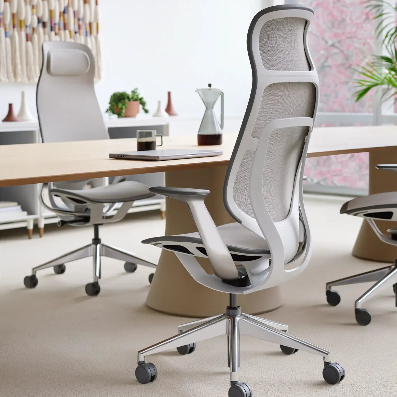 Steelcase Karman high back Seagull ergonomic office chair with light frame and mesh design in modern workspace.
